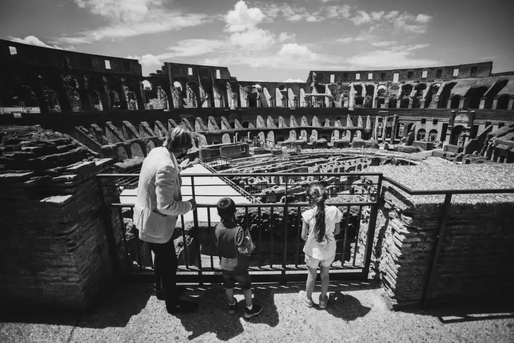 Private Rome tours for families with kids walking on the Colosseum Arena Floor through the Gladiator’s Gate.